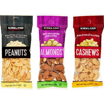 Three snack-sized packages of Kirkland nuts—peanuts, almonds and cashews—for a story on packaged Costco snacks for kids