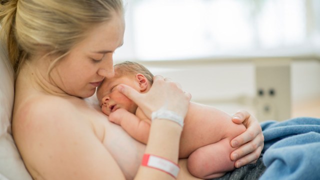 a mom doing skin to skin with her newborn in the hospital for a story on things not to do after giving birth