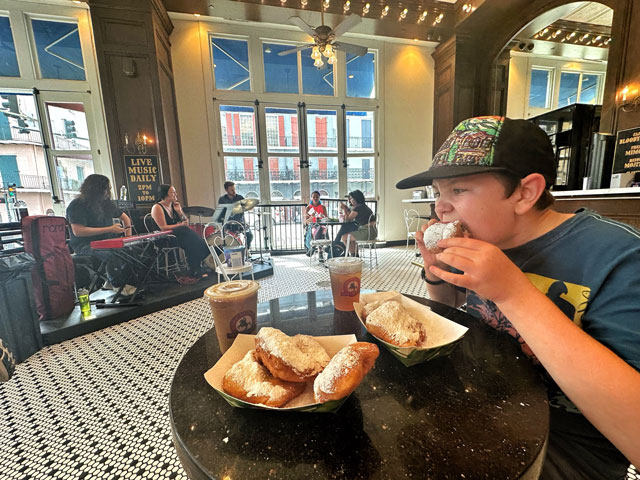 child eating beignets in New Orleans