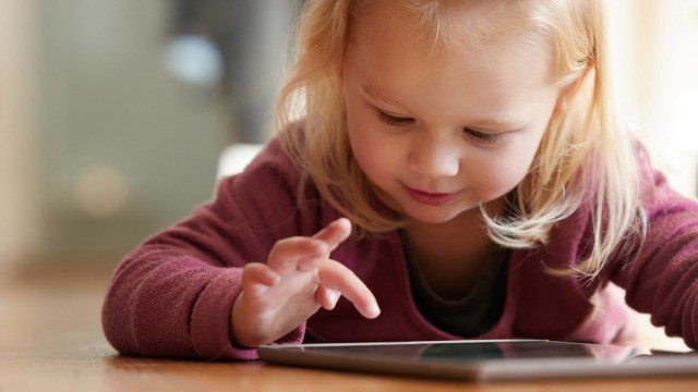 a toddler playing on a tablet for a roundup of the best toddler apps