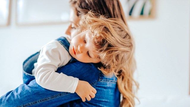 kid hugging mom because this toddler prefers one parent