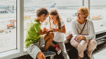 a family playing waiting games while at the airport gate