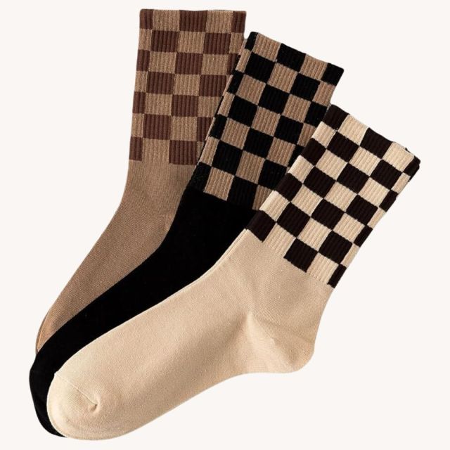 three checkered print socks in neutral colors