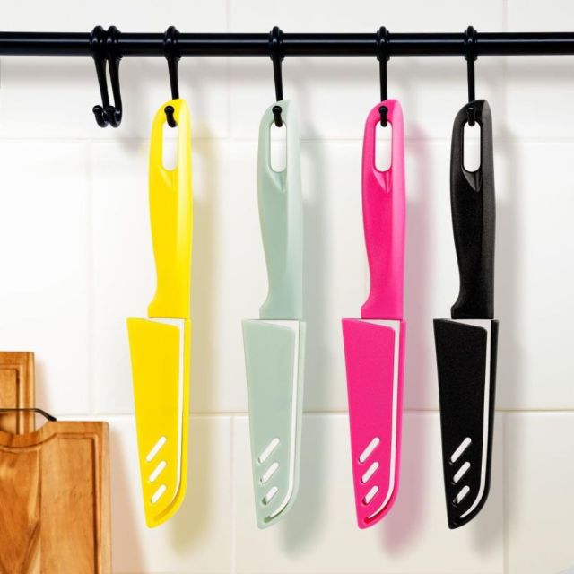 set of four bright colored knives hanging on kitchen knife rack