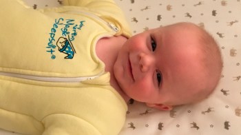 a close up of a baby in a baby merlin's magic sleepsuit