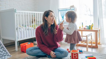a mom playing a game with her daughter that helps with baby's first words