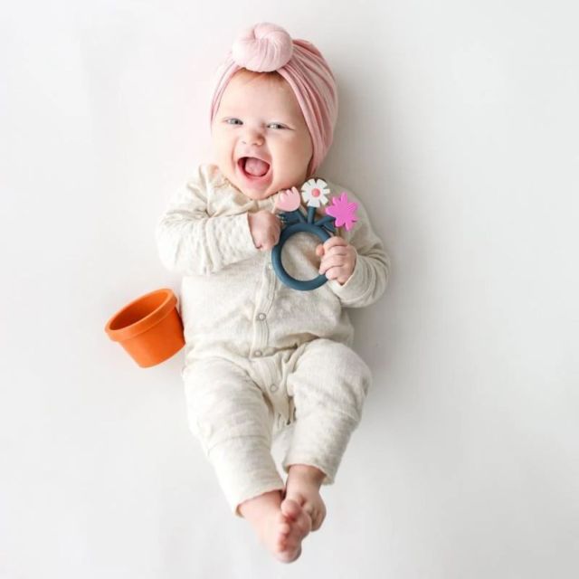 baby girl with flower pot teether