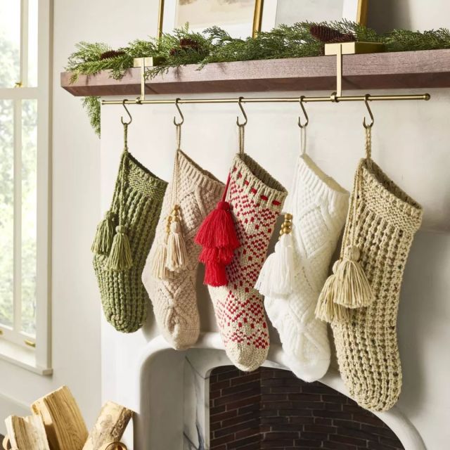 five knit stockings hanging on hooks