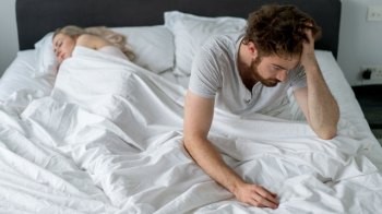 man waking up from a bad night of sleep.