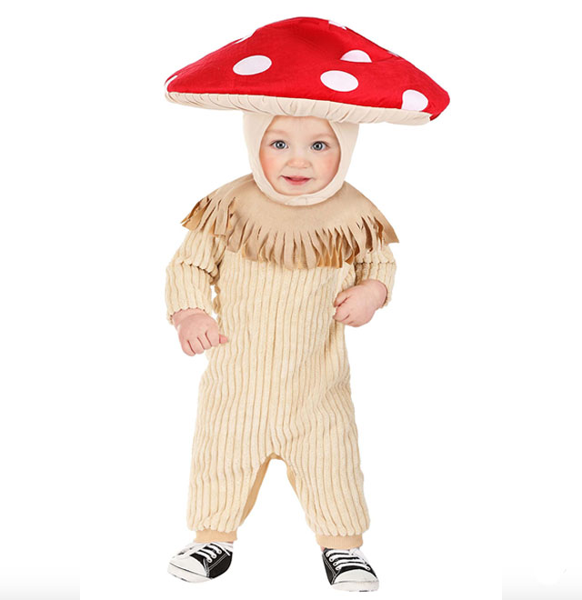 a baby in a beige baby costume with a red and white mushroom hat