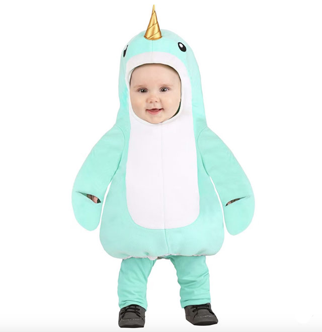 A toddler in a puffy blue narwhal baby costume