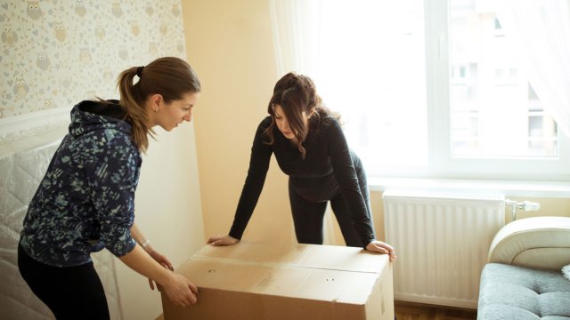 women unpacking boxes
