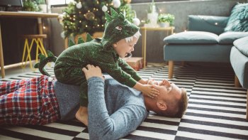 boy and dad playing during Christmas time