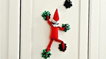 an elf on the shelf rock climbing up a door on gift bows for a story of easy elf ideas