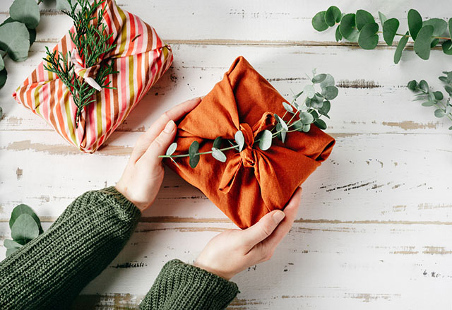 Placing a sprig of greenery in your wrapping is one of the best gift wrapping hacks