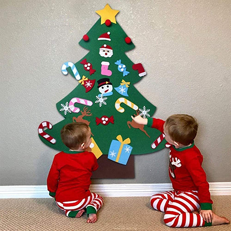 a felt christmas tree attached to the wall for toddlers to decorate as an example of a toddler-proof christmas tree