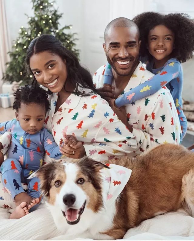 family wearing christmas tree printed pajamas