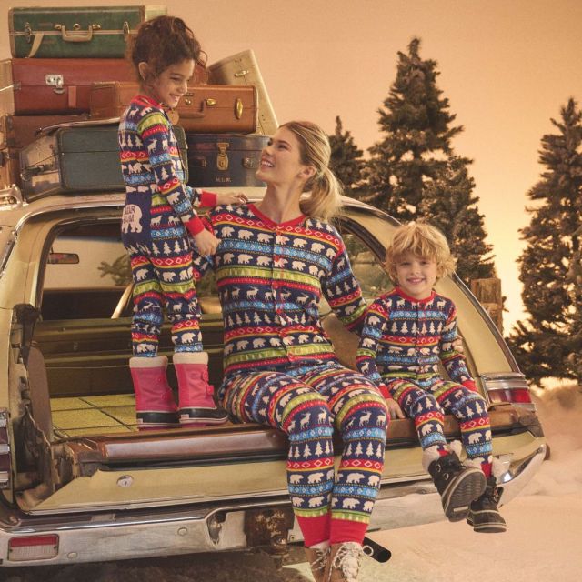 family wearing matching holiday onesies