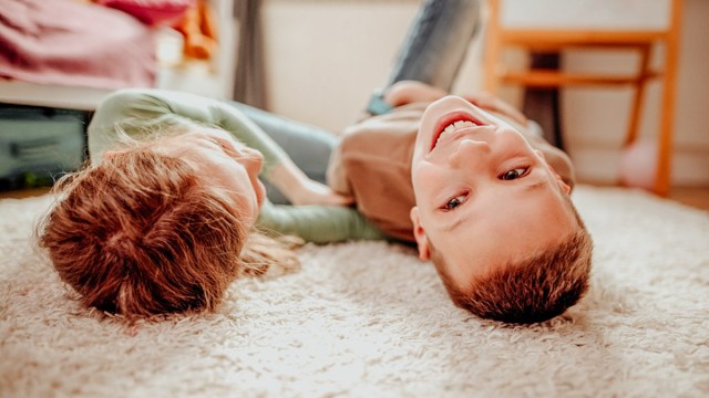 two siblings playing on the floor for a story on using code words when things get challenging