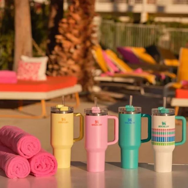 4 stanley tumblers in summer colors at a poolside