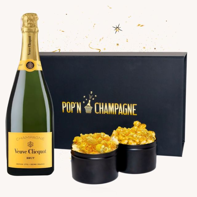 bottle of champagne and two tins of popcorn