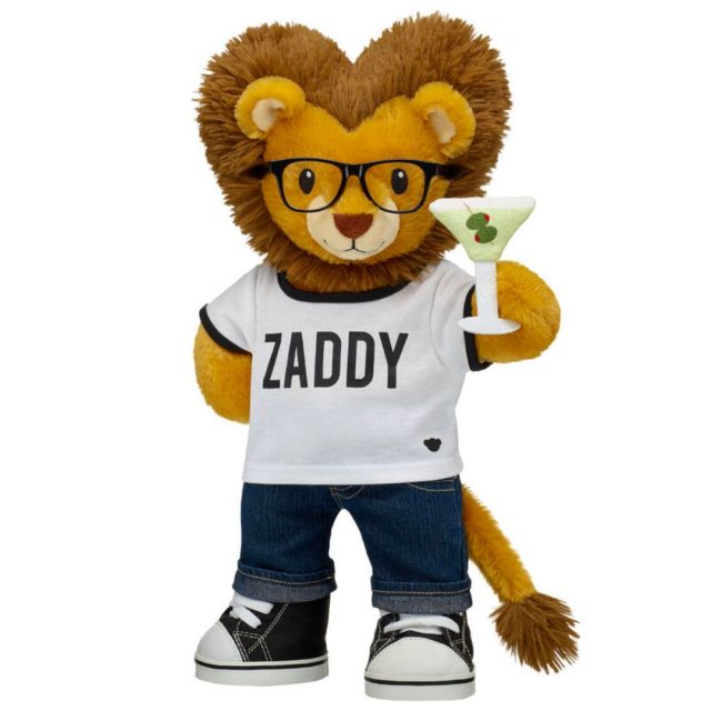 stuffed lion in jeans, a t-shirt, sneakers, glasses, and holding a martini