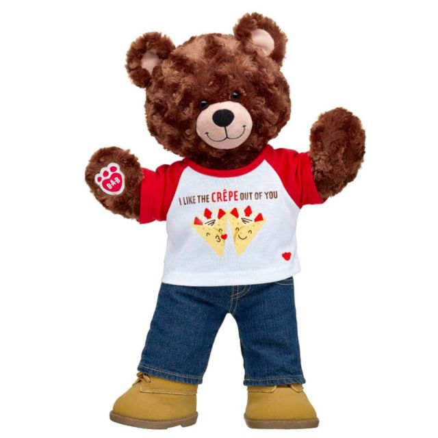 brown stuffed bear wearing t-shirt, jeans, and work boots