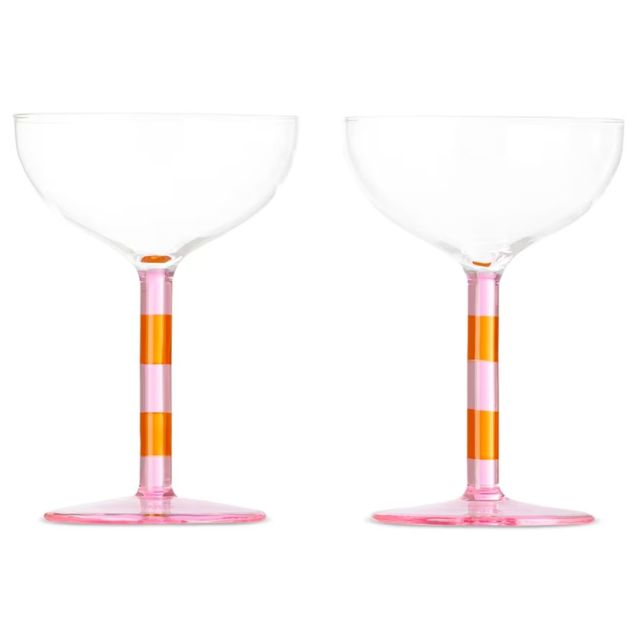 two coupe glasses with pink and brown striped stems