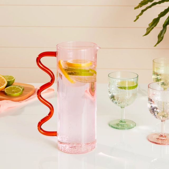 pink glass pitcher with wavy handle