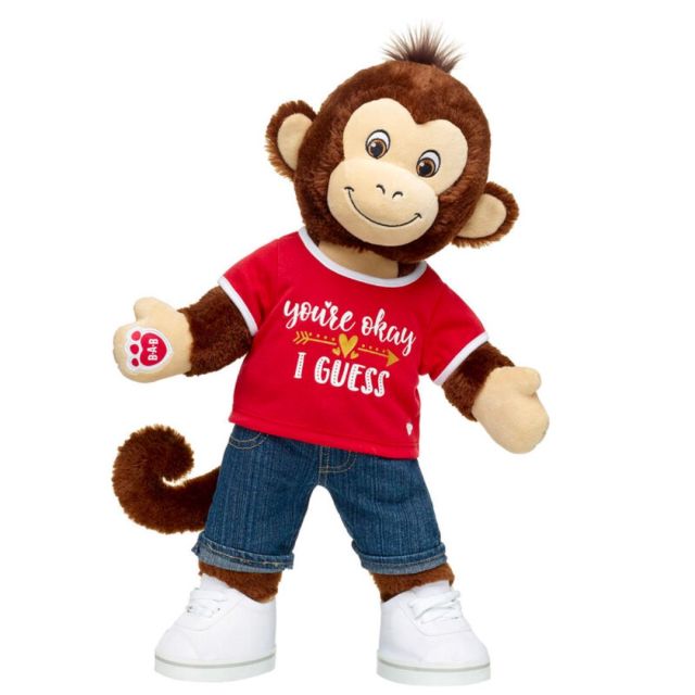 plush monkey in red t-shirt, denim shorts, and white sneakers