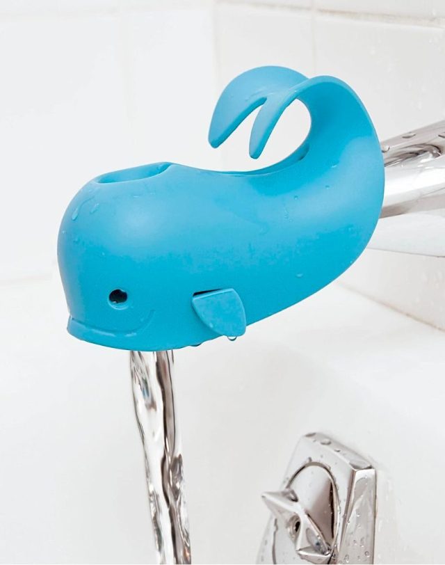a blue whale shaped faucet cover over a bathtub faucet