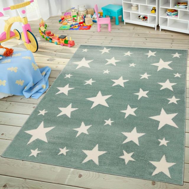 greyish blue rug with white star print in a toy room