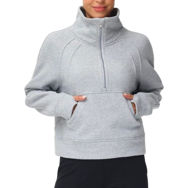 woman wearing a grey 1/2 zip pullover