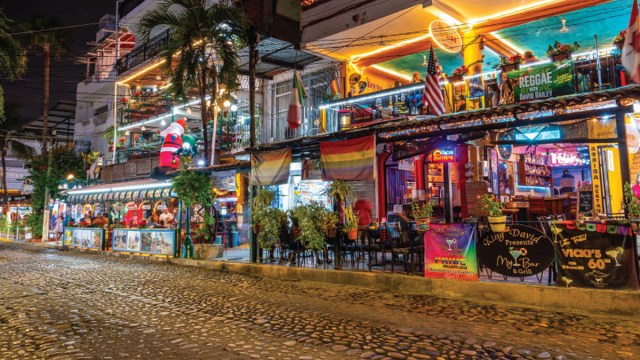a street with brightly lit bars in the Zona Romantica, one of the fun things to do in Puerto Vallarta