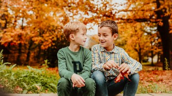 two boys sitting and talking