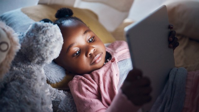 a little girl on her ipad who might have a meltdown when ipad time is over