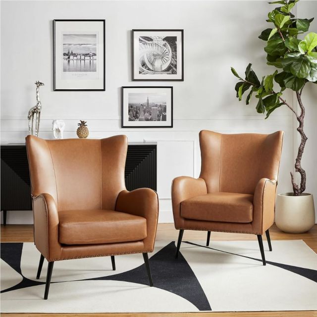 set of two brown leather wingback chairs in living room