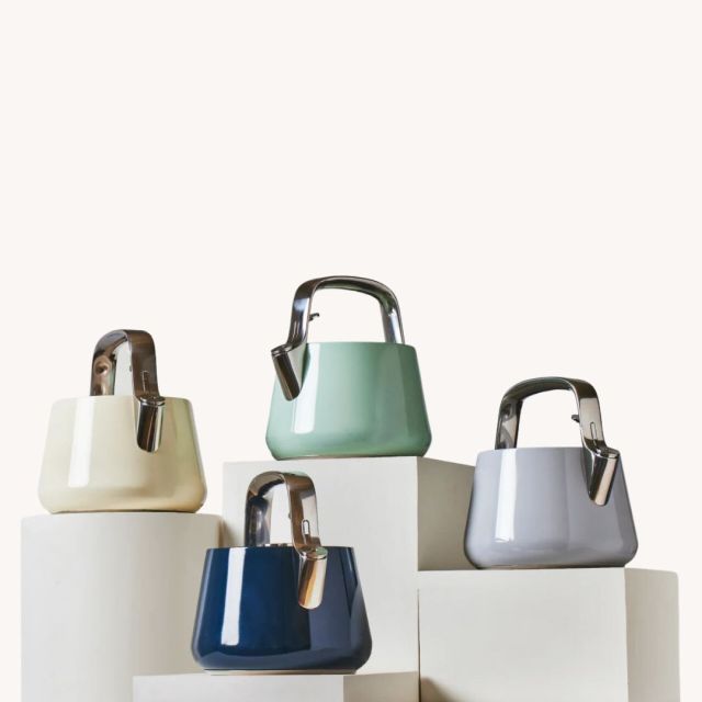 4 colored tea kettles on display stands