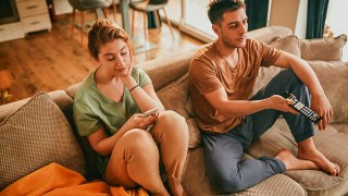 couple sitting on the couch not talking