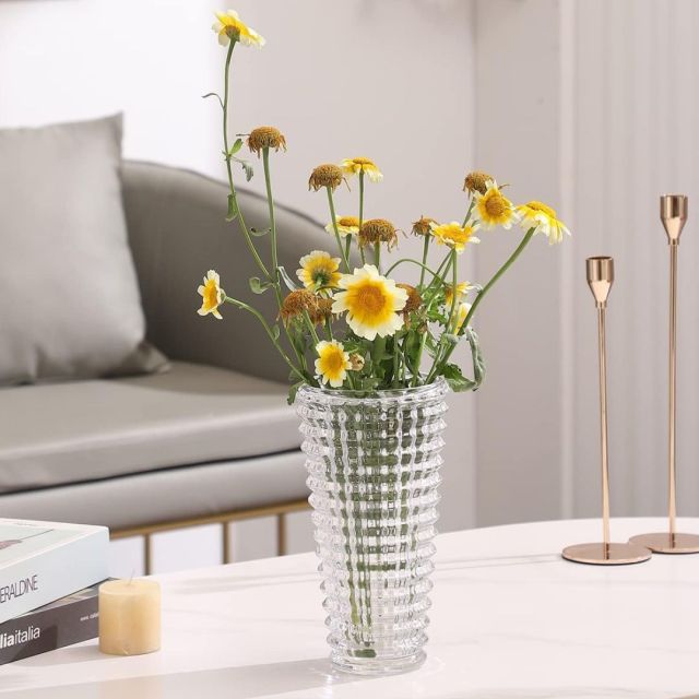 crystal vase on coffee table holding yellow flowers