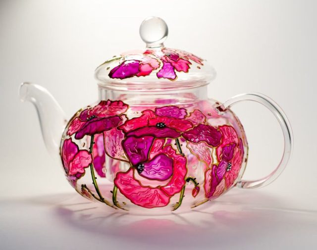glass teapot embossed with red and pink floral design