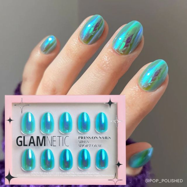 hand with shiny teal press on nails