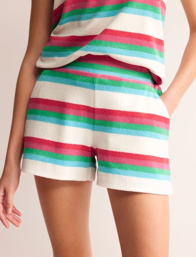 bottom half of woman wearing striped shorts