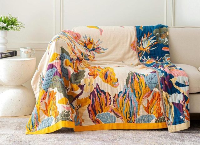 bird and floral blanket draped over couch