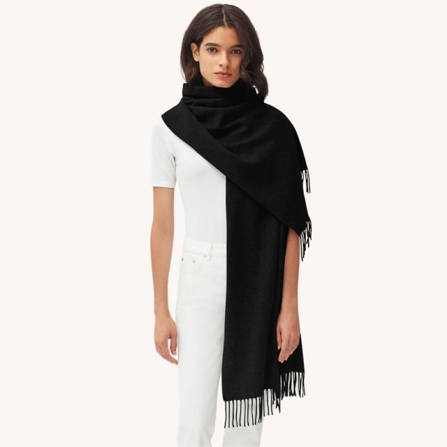 woman in white standing in a long black scarf