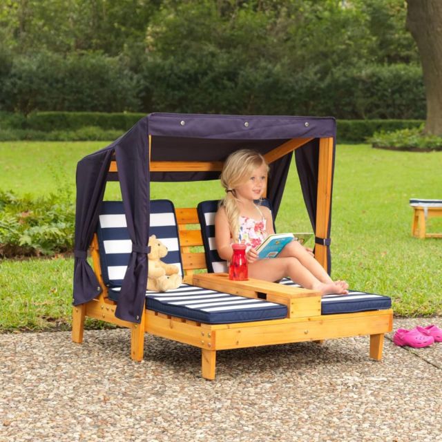 little girl lounging on double kids size outdoor chaise lounge