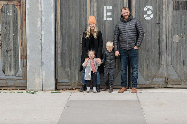 a professional photo of a family dressed in neutrals with a pop of peach, one of the best family photo outfit ideas