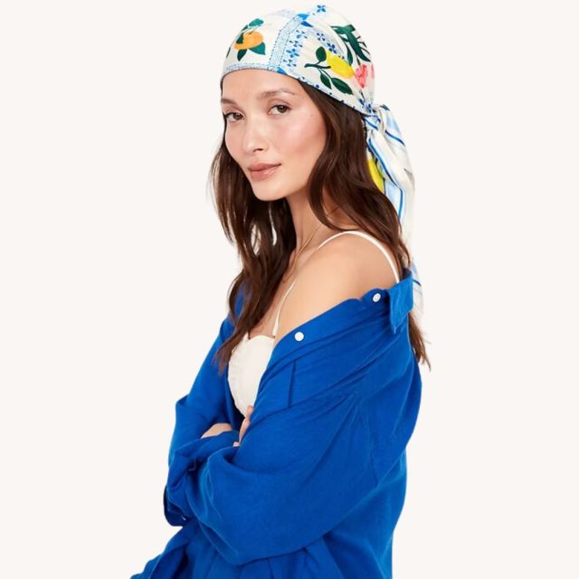 woman wearing blue shirt and fruit-printed head scarf