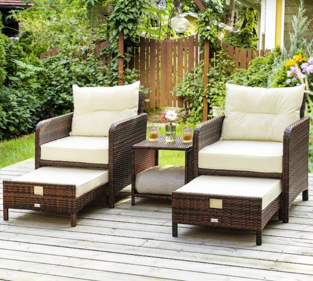 set of wicker patio furniture in a backyard