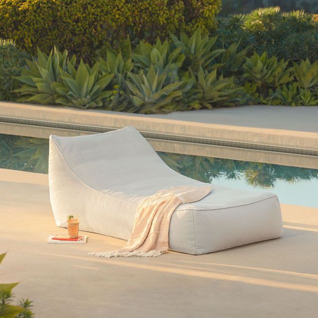 grey plush lounger by the pool